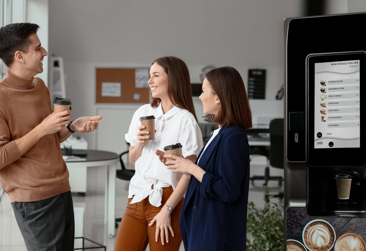 Office team gathering for gourmet coffee from a touchscreen coffee vending machine in a Tulsa workplace
