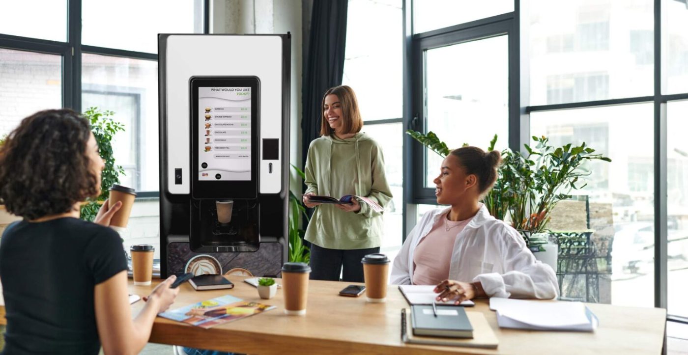 Coworkers enjoying fresh café-quality office coffee together in a bright Tulsa breakroom